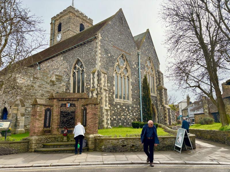 An old church building featuring grave stones on the outside