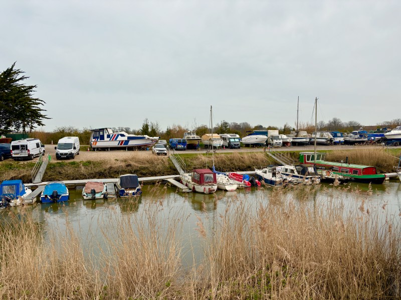 A river with docked boats on the side