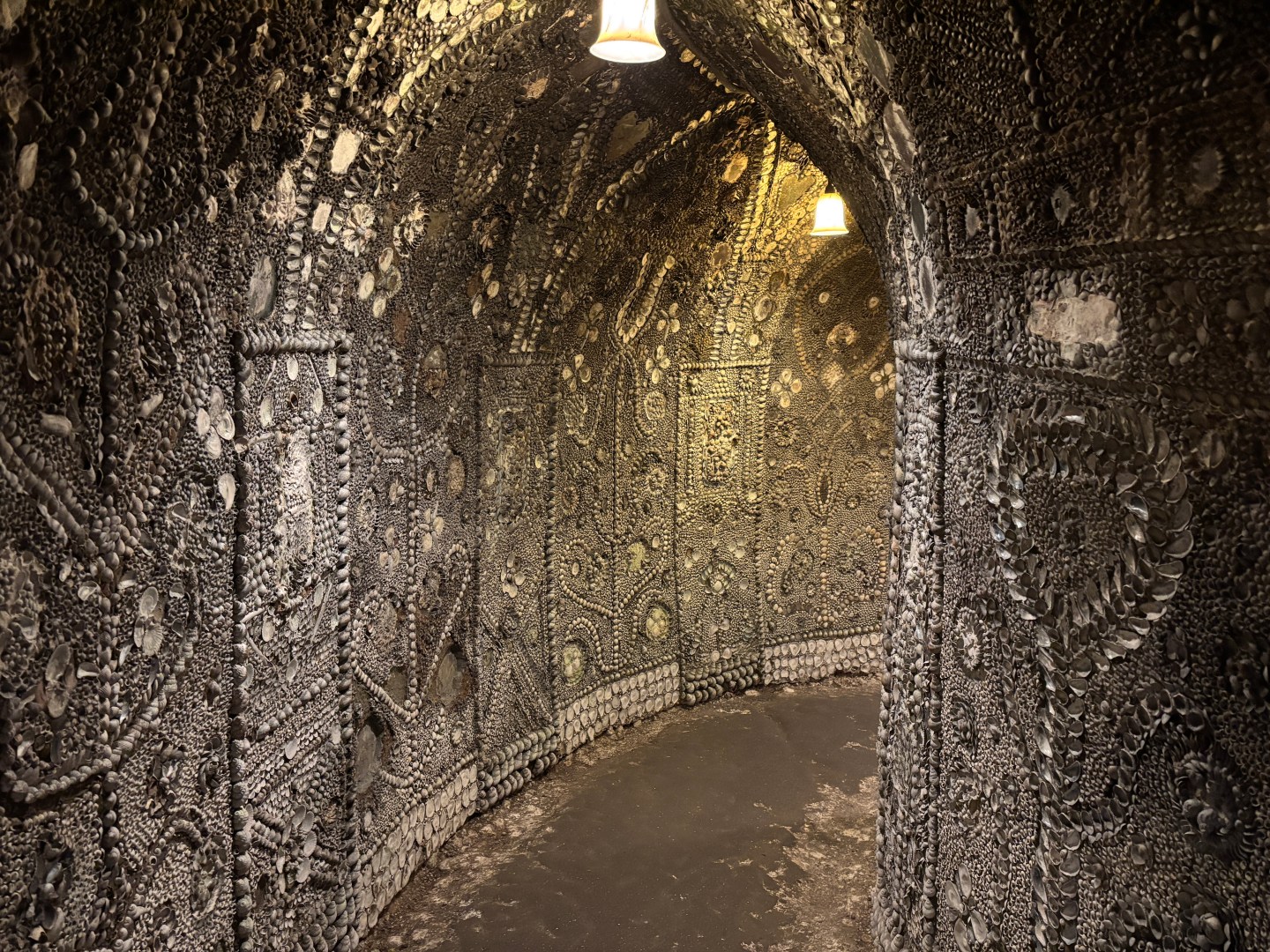 A tunnel where the walls are covered in seashells
