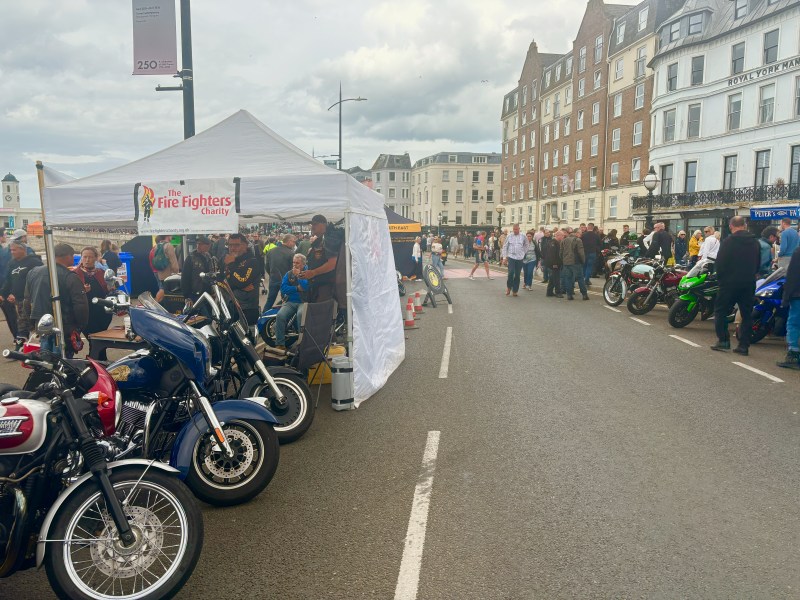 A busy road featuring motorbikes and a tent
